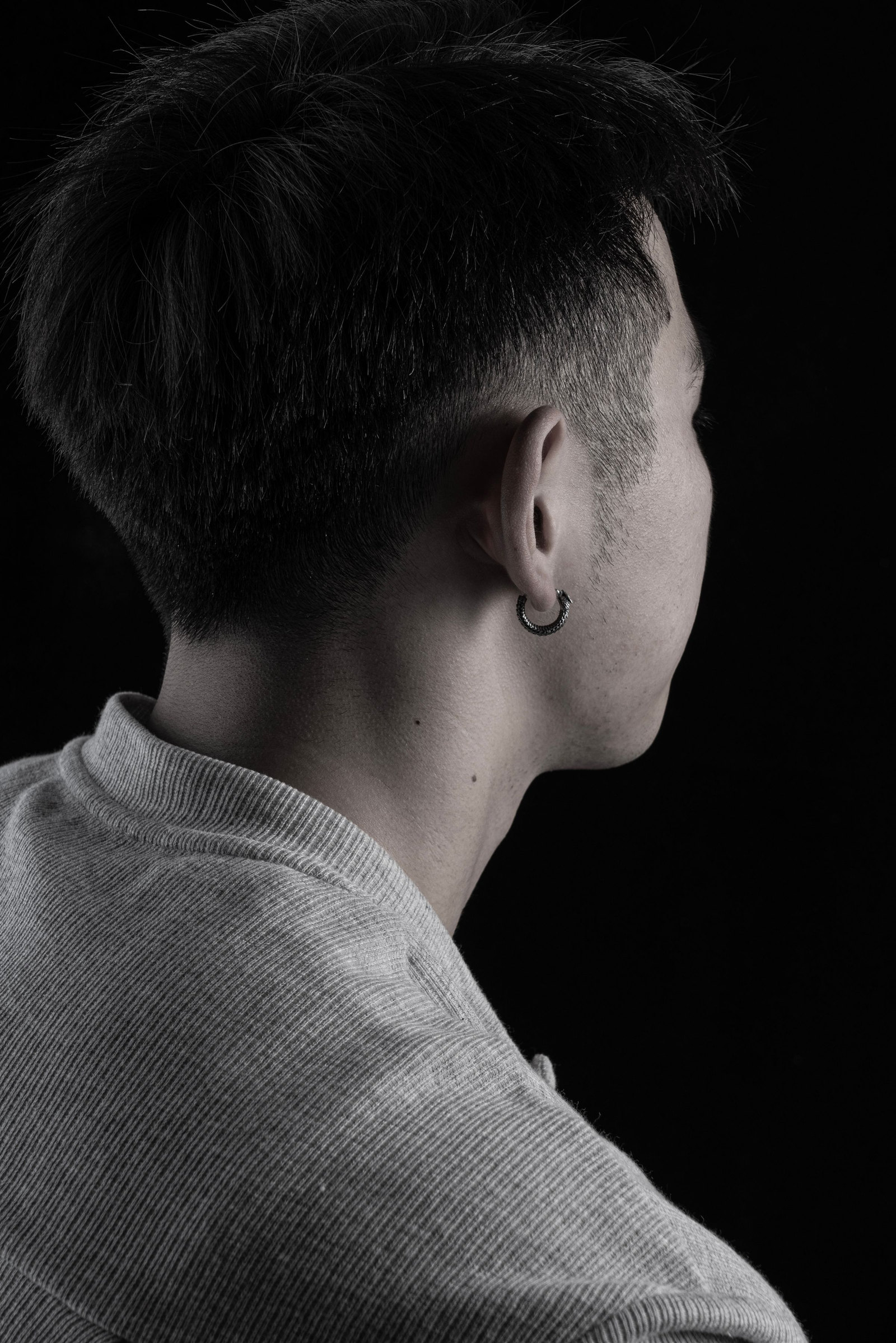 The back of a freshly cut skin fade, shot against black