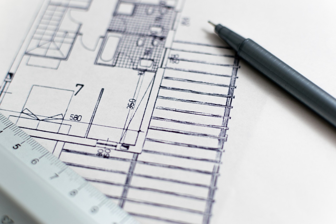 A floor plan with pen and scale ruler