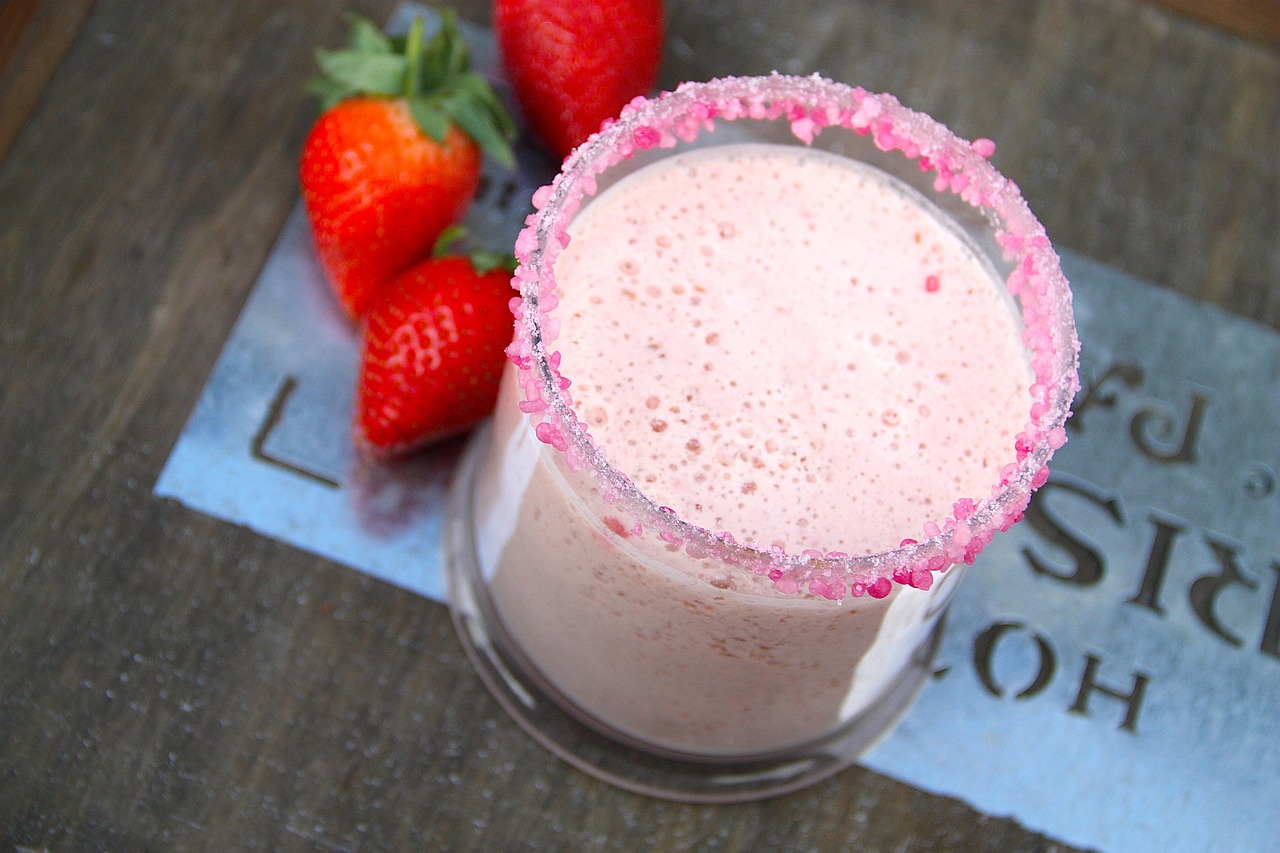A strawberry milkshake with a sprinkled rim