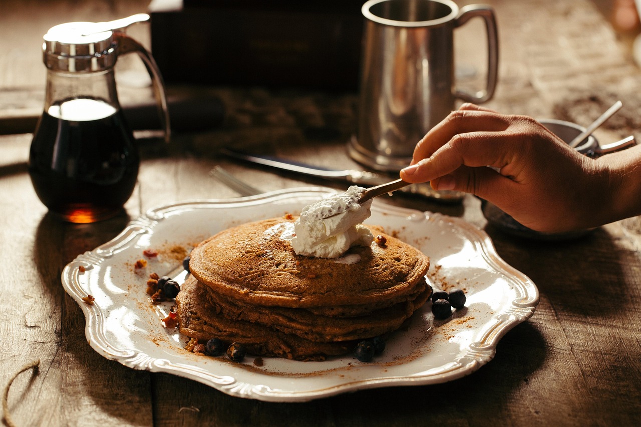 Pancakes with whipped cream on a vintage plate