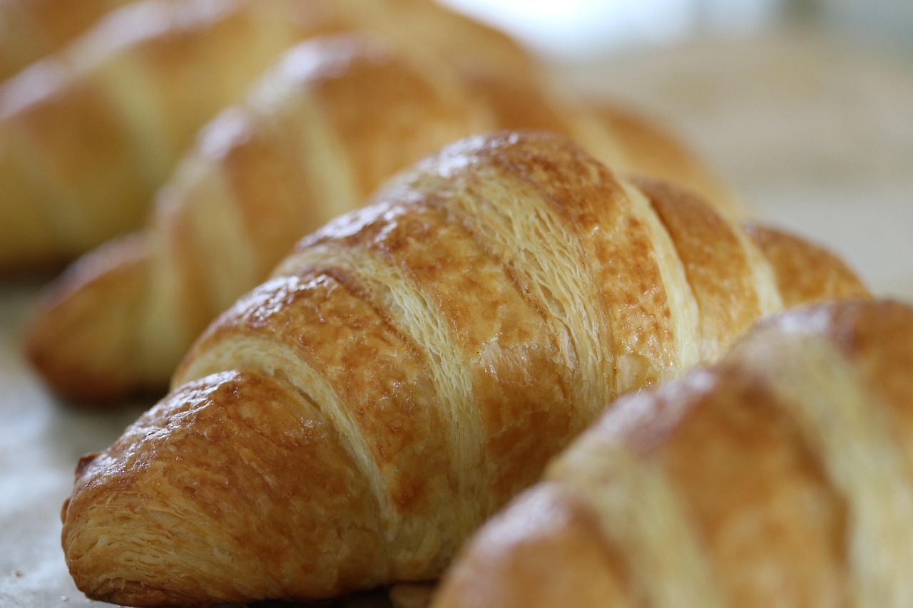 Golden croissants in close warm light
