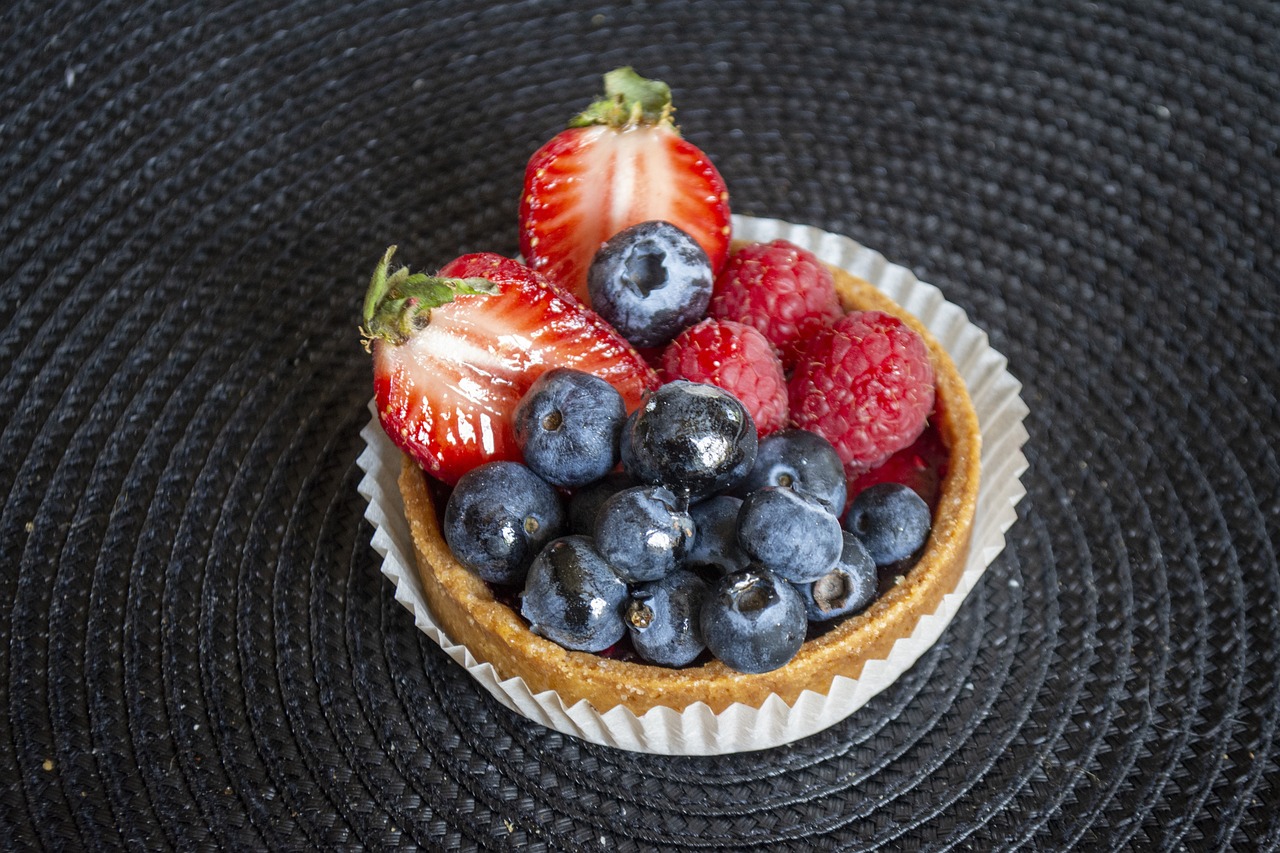 A berry tartlet piled with strawberries and blueberries