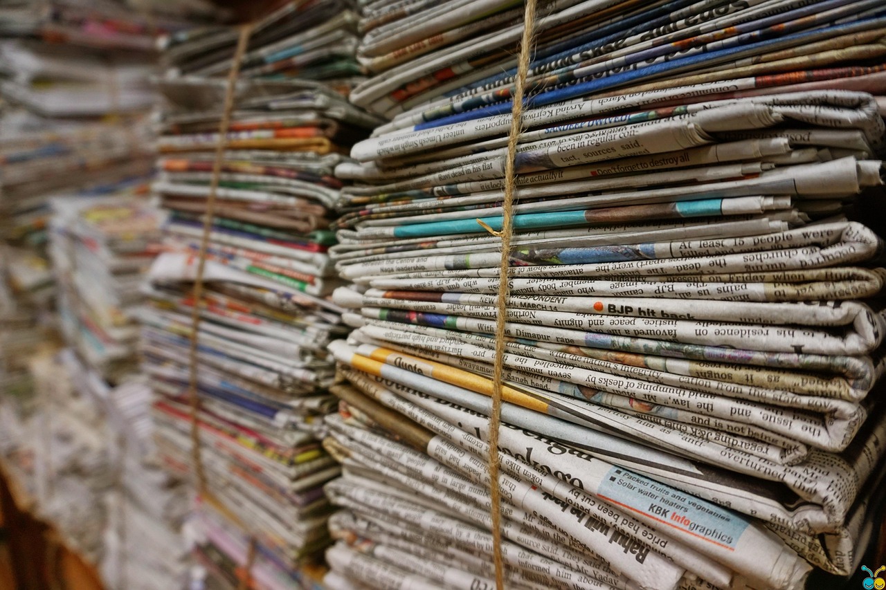 Bundles of newsprint tied with twine