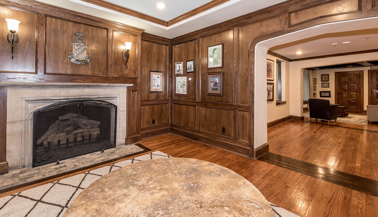 A wood-panelled meeting room with a stone fireplace
