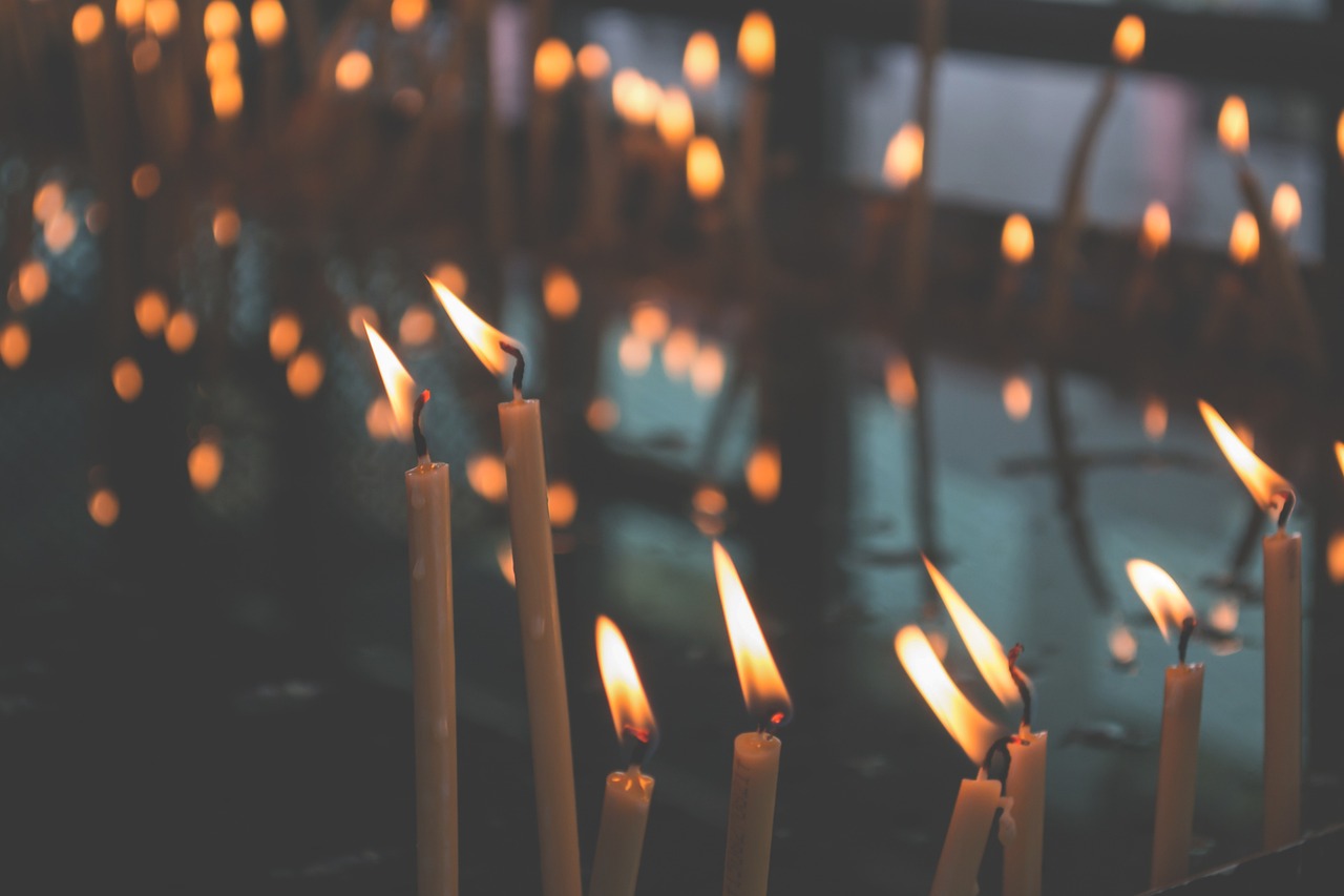 Candles glowing warm against the dark