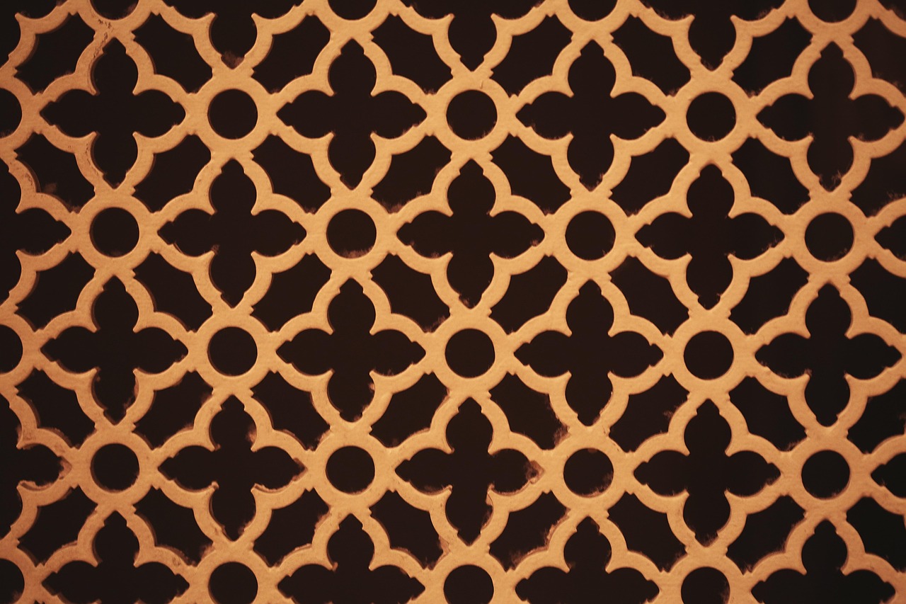 A gold geometric lattice pattern against black