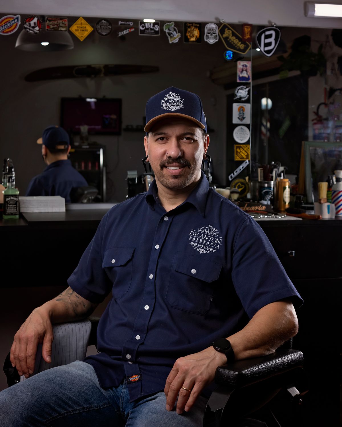 Marcus seated in a barber's chair in the shop