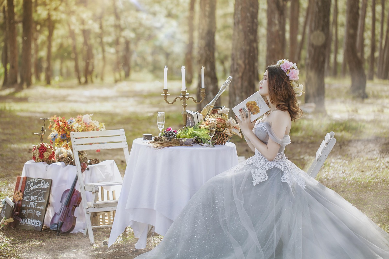 A bride reading vows at a small woodland table