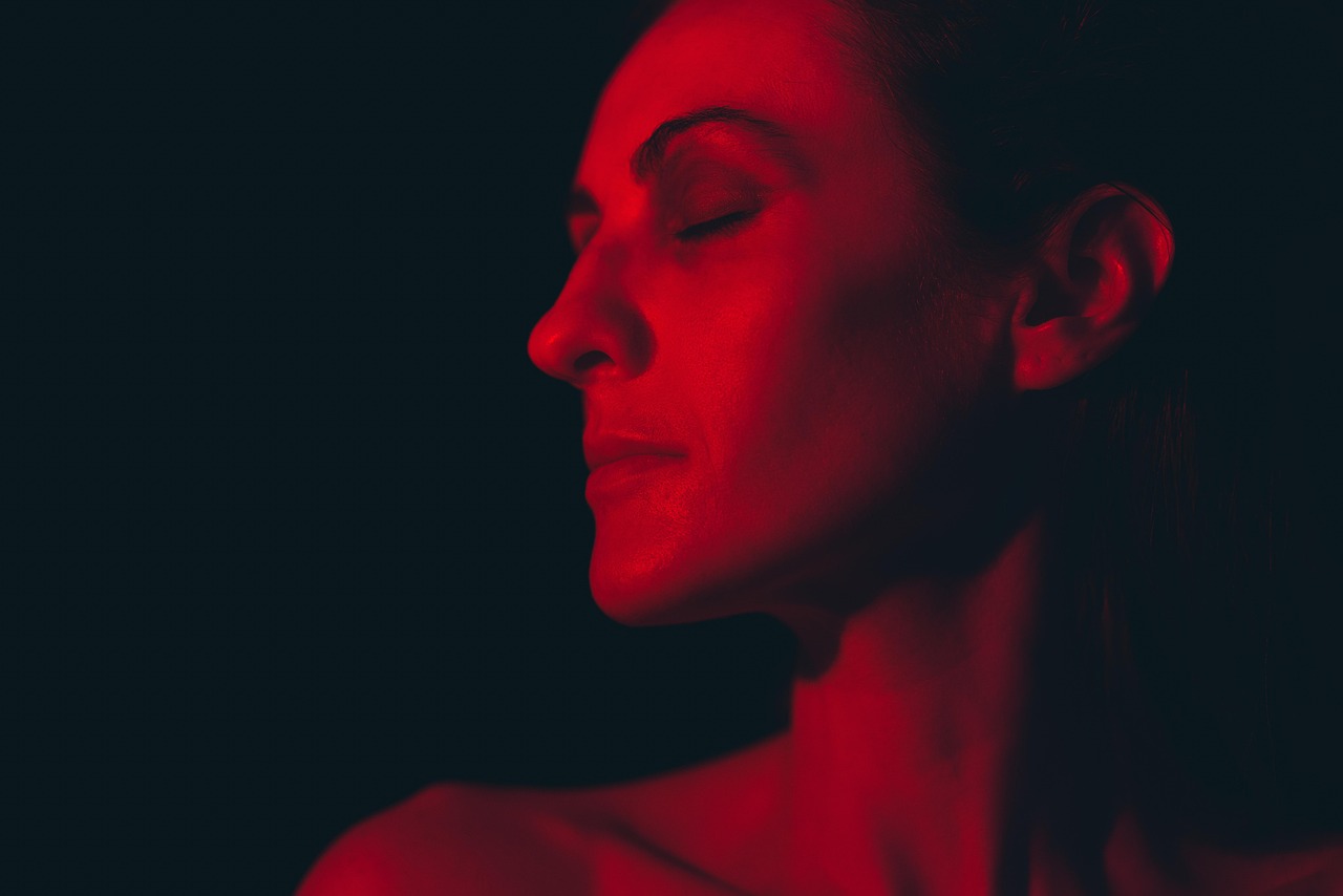 A profile bathed entirely in red light against black
