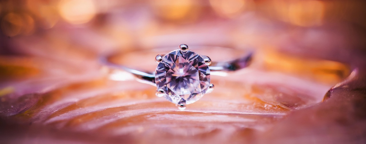 A solitaire diamond ring in warm evening light