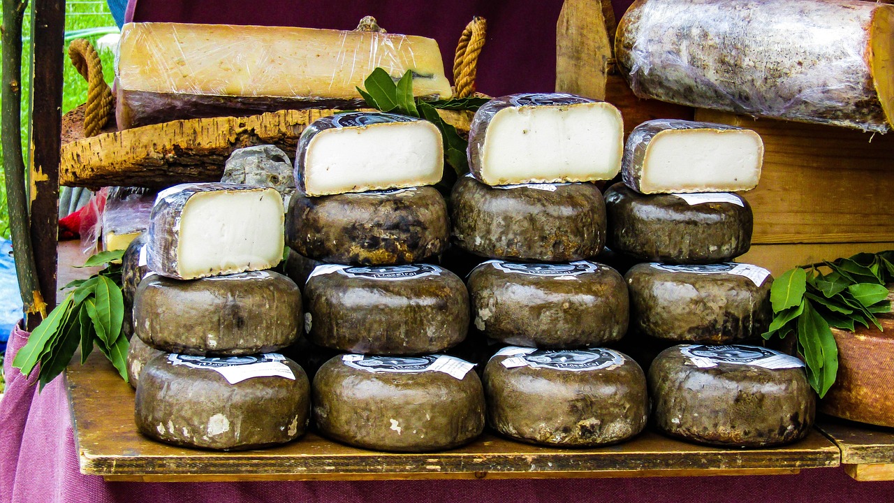 Stacked wheels of farmhouse cheese with bay leaves