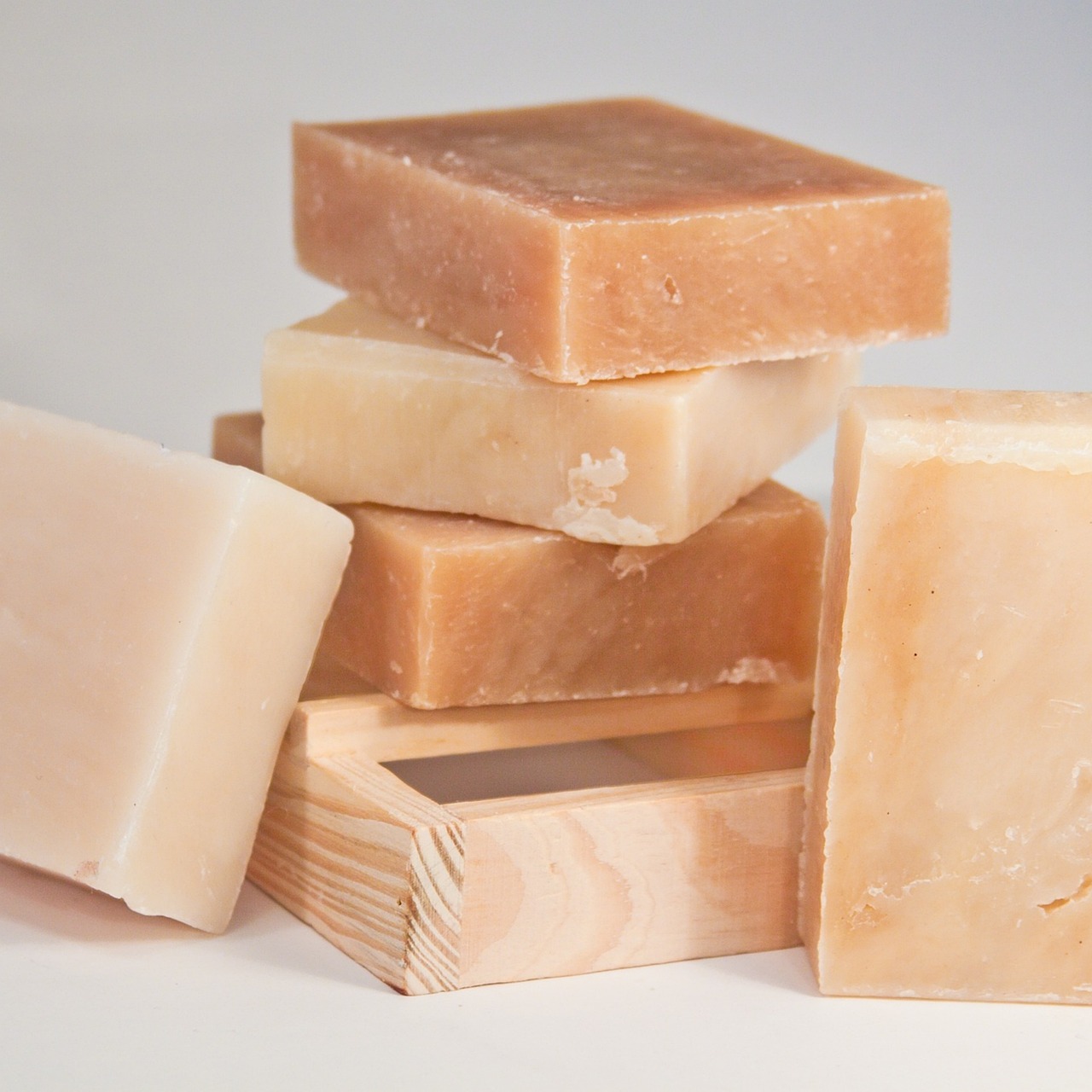 Natural soap bars in warm taupe tones stacked on a wooden tray