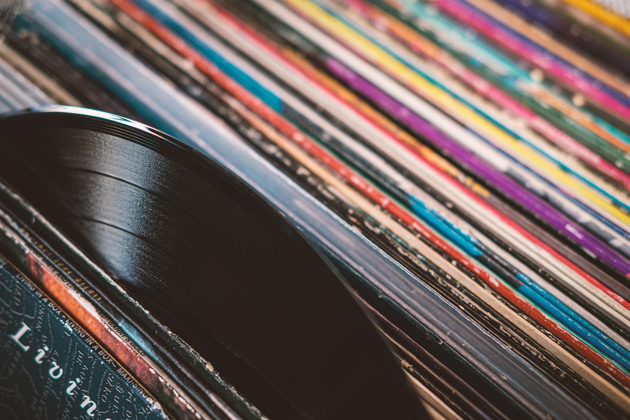 A record pulled halfway from a row of colourful sleeves